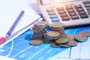Double exposure of city and rows of coins for finance and banking concept