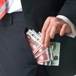 man showing foreign currency in pocket