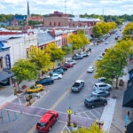 Real estate investment that an entrepreneur should consider blog post art: Small busineses in a downtown village.