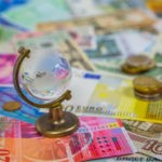 Picture for Section 951 GILTI tax blog post showing a tiny glass globe against background of currency