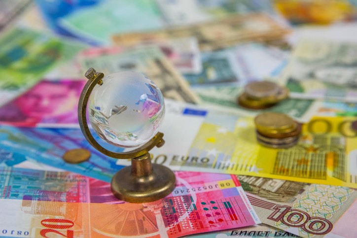 Picture for Section 951 GILTI tax blog post showing a tiny glass globe against background of currency