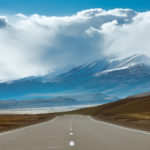 Picture for long run retirement returns blog post shows Straight road in mointains area. Siberia, Russia
