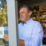 Picture of small business owner opening his wine shop