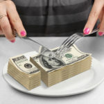 Picture for pass through entity tax cuts rules blog post shows a stack of dollar bills being cut up