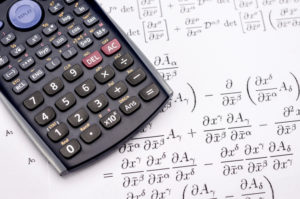 A picture of a Scientific calculator and mathematical equations for the calculus of growth 