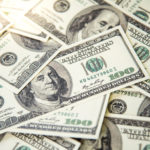 Pile of banknotes of one hundred dollars. Selective focus. Closeup. Background.