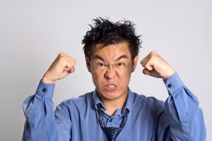 Picture of angry accountant clinching fists and scowling.