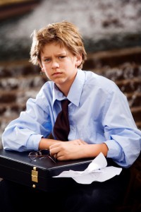 Picture of boy in dress shirt and tie holding briefcase