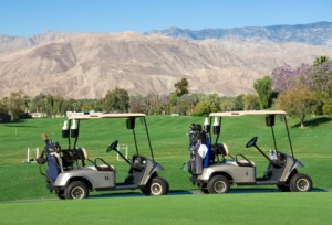 Picture of golf carts on course in desert.