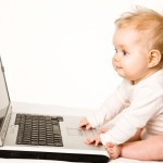 Picture of baby in front of computer.