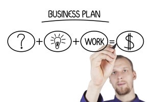 Picture of entrepreneur working on clear writing board.