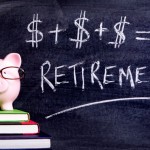 Picture of Pink piggy bank with glasses standing on books next to a blackboard with simple retirement formula. Sharp focus on the piggy bank.