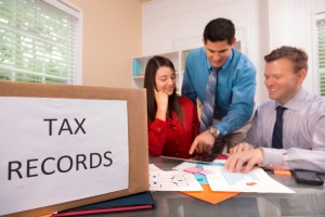 Picture of small business owners and accountant working on taxes.