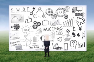 Picture of man standing in front of gigantic whiteboard.