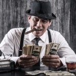 Picture of man smoking cigar and counting money.