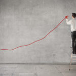 Picture of man going financial planning for top one percent at blackboard