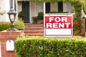 Picture of For Rent sign in front of rental house.