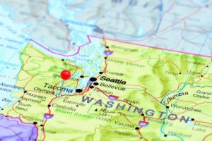 Photo of pinned Olympia on a map of USA. May be used as illustration for travelling theme.