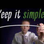 A businessman writing Keep It Simple on a screen. Business Concept.