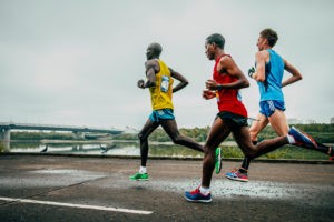 Picture of Omsk, Russia - September 20, 2015: three leaders of the marathon running along the embankment of the Irtysh river during Siberian international marathon