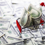 Shopping trolley with dollars. Sale.